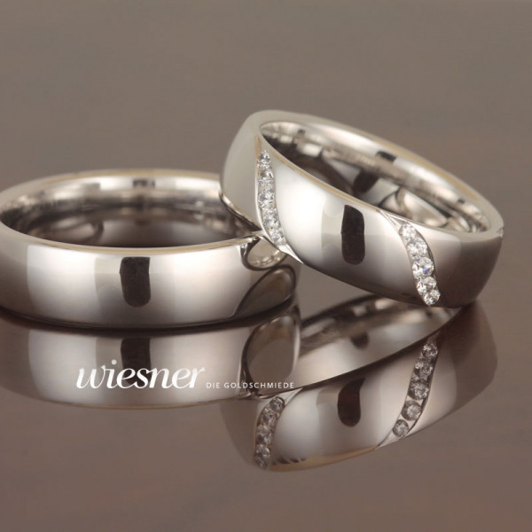 Polished white gold wedding rings with diamonds in ladies ring