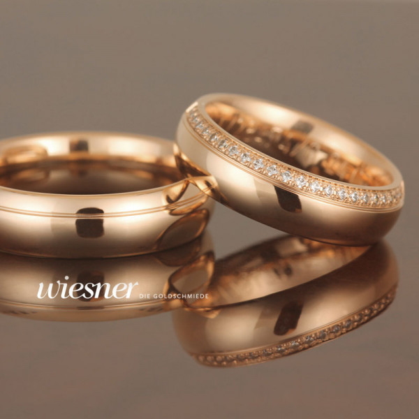 Gerstner wedding rings in strong yellow gold with a multitude of diamonds