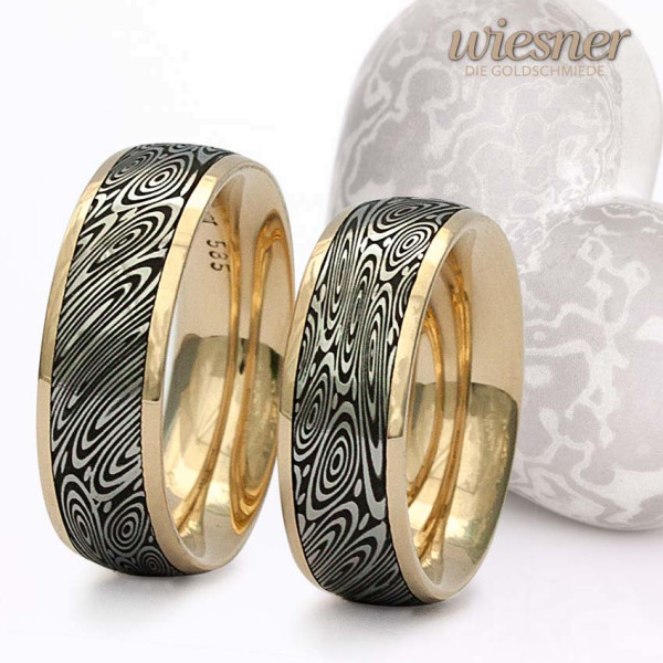 Damascus Steel Rings with eye damascus pattern and yellow gold inner ring.