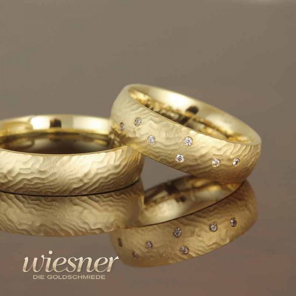 Gerstner wedding rings in structured yellow gold with diamonds 