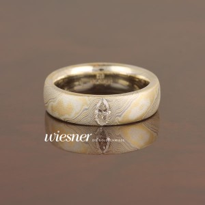 Engagement ring with navette cut diamond 0.25 carat in mokume gane